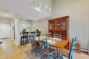 a kitchen and dining room with a table and chairs at Newton Village 2B in Quechee