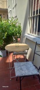 a table and two chairs on a patio at PALAZZO NOVECENTO WELLNESS B&b in Lecco +60 photos