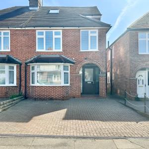 a red brick house with a black door at 4 Bedroom House, En-Suite, 3 Doubles 1 Single, 2 Car Parking in Colchester