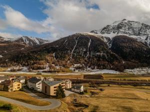 a small town in front of a mountain at La Senda Smart Hotel Zuoz in Zuoz