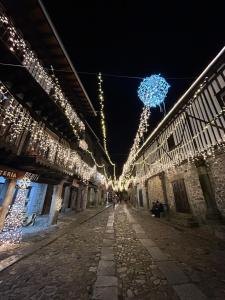 un callejón con luces de Navidad en un edificio en El Rincón Templario, en La Alberca