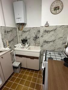 Airb&b Mery Milano-Cortina في ميلانو: مطبخ صغير مع حوض وموقد