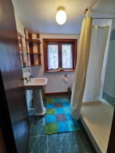 a bathroom with a tub and a sink and a shower at Mountain Cottage with Barn Sauna, Clonbur, Galway in Clonbur