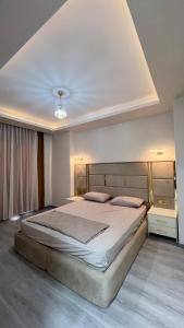 a bedroom with a large bed in a room at Aljari otel in Mezitli +4 photos