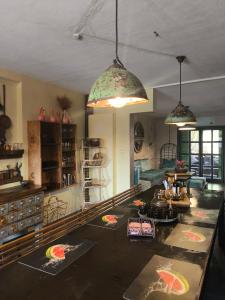 a kitchen with two pendant lights and a table at הבית החום בערבה in Sappir