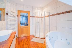 a white bathroom with a tub and a sink at Ma Vie'La - Swimming Pool - Balneo - Jacuzzi - Sauna in Rhinau +12 photos