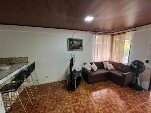 a living room with a couch and a fan at Serene Oasis Hideaway in Fortuna