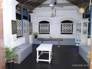 a room with a table and benches in a building at Grandma's House Villa in Weligama
