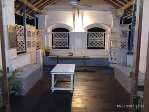 a room with a table and a bench in it at Grandma's House Villa in Weligama