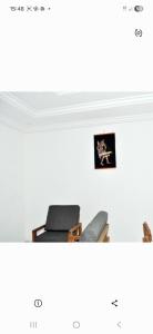 a room with a chair and a picture on a wall at Résidence 2B in Douala