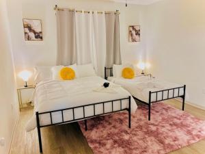 a bedroom with two beds and a pink rug at Cozy & Chic Frisco Scape in Frisco +19 photos