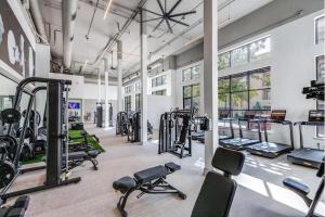 a gym with several treadmills and machines at Cozy & Chic Frisco Scape in Frisco