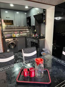a kitchen with a table with red cups on it at Dachi Apartment in Sighnaghi +7 photos