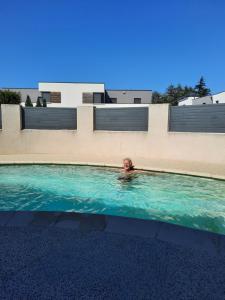 a person swimming in a swimming pool at Voie bleue Bords du Rhône in Guilherand