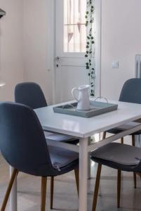 a dining room table with a laptop and chairs at Lithaia Aura-Trikala in Pýrgos