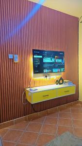 a tv on top of a wooden wall at Kilifi Beach Haven -Cozy 1 bedroom apartment in Kilifi