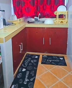 a kitchen with a sink and a kitchen floor mat at Kilifi Beach Haven -Cozy 1 bedroom apartment in Kilifi
