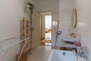 a bathroom with a tub and a sink and a mirror at Gemütliche 2-Raum-Wohnung in Leipzig