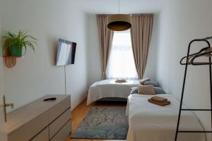 a bedroom with two beds and a window at Gemütliche 2-Raum-Wohnung in Leipzig