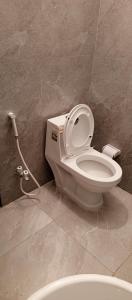 a bathroom with a toilet with a water hose at Royal Continental DHA Karachi in Karachi