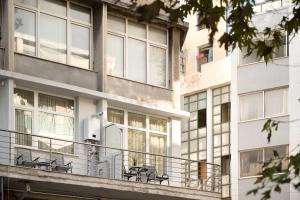 Executive Suite - Estia Premium Apartments في سلانيك: شرفة مبنى عليه مقاعد