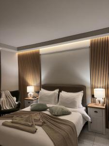 a bedroom with a large bed with two lamps at DIVINUS Luxury Stay in Markopoulo