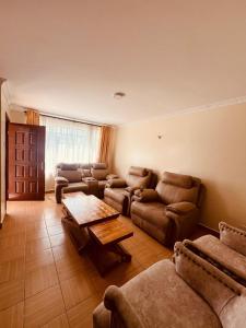 a living room with couches and a table at Cleo luxe villa in Makandara