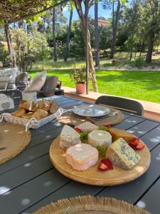a table with two plates of cheese and bread at N&L Signature - Chambre d'hôtes in Mornas