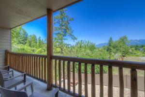 a balcony with chairs and a view of the mountains at Whitefish Riverfront Hotel in Whitefish +157 photos