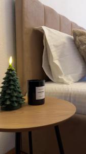 a candle and a christmas tree on a table at Ultracentral 13 in Craiova
