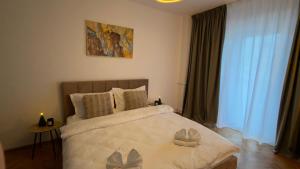 a bedroom with a bed with two candles on it at Ultracentral 13 in Craiova +3 photos