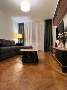 a living room with a couch and a table at Ultracentral 13 in Craiova