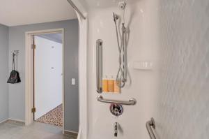 a bathroom with a shower and a mirror on the wall at Whitefish Riverfront Hotel in Whitefish