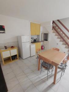 a kitchen and dining room with a table and refrigerator at CASA GENTILE in Giovinazzo