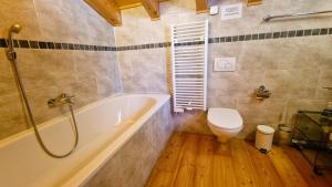 a bathroom with a tub and a toilet in it at Chalet La Giete 6 personnes La Forclaz in Haudères +13 photos