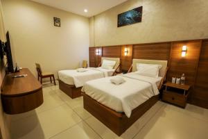 Ένα ή περισσότερα κρεβάτια σε δωμάτιο στο Townsquare Residency