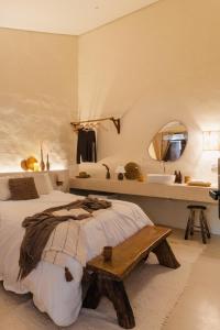 a bedroom with a bed and a mirror and a sink at Mōmento Itamambuca in Ubatuba +78 photos