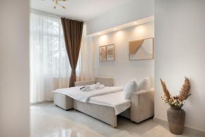 a white bedroom with a bed and a window at Estia Premium Apartments - Superior Suite Vackhou 1 in Thessaloniki +16 photos