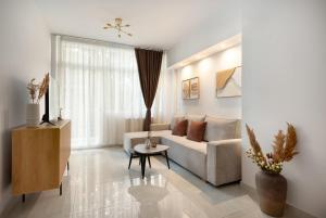 a living room with a couch and a table at Estia Premium Apartments - Superior Suite Vackhou 1 in Thessaloniki