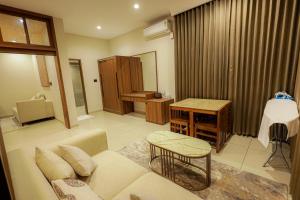 a living room with a couch and a table at Town Square Residency in Kommeri