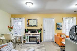 a living room with an orange couch and a mirror at Fireplace • Grill • Gym‑Ready • Near Bull Run in Centreville