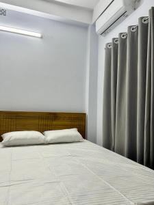 Ένα ή περισσότερα κρεβάτια σε δωμάτιο στο Sribhumi Homestay