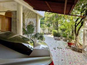 a car parked in front of a house at Sribhumi Homestay in Sreemangal