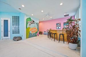een kamer met een bar met een roze muur bij Oceanfront 6BR Indoor Pool Theater Funky Fun in Cocoa Beach