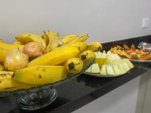 a bowl of bananas and other food on a table at Hotel Bonina in São Paulo
