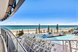 a view of the beach from the balcony of a resort at Soul Beachfront Apartments - HR Surfers Paradise in Gold Coast