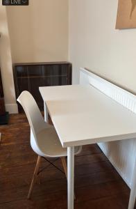 a white table and a white chair in a room at 28 Russell road in Bristol