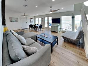 a living room with a couch and a table at Our Infinity Pool in Galveston +46 photos