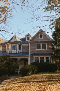 a brown house with a blue roof at Charming Country Home with Hot Tub, Pond & Creek in New Paltz