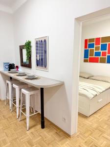 a dining room with a table and a bed at M8 ParkSide Studio One in Graz
